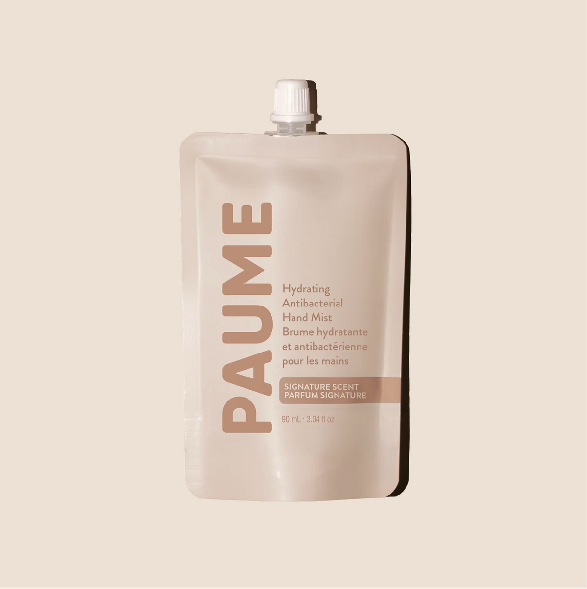PAUME hand mist packaging on a beige background