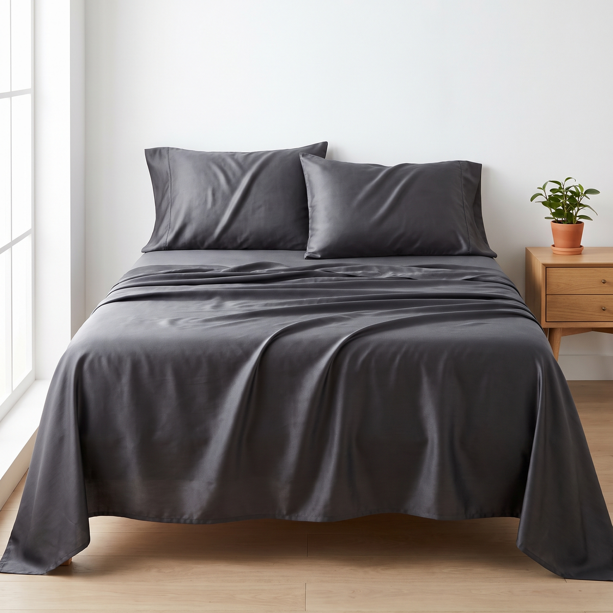 Canadian Comfort organic bamboo sheet set in dark grey on a queen bed